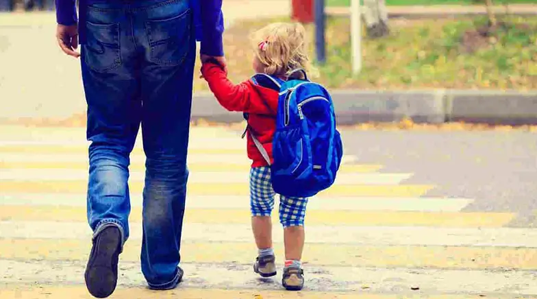 Dad and young son walk together