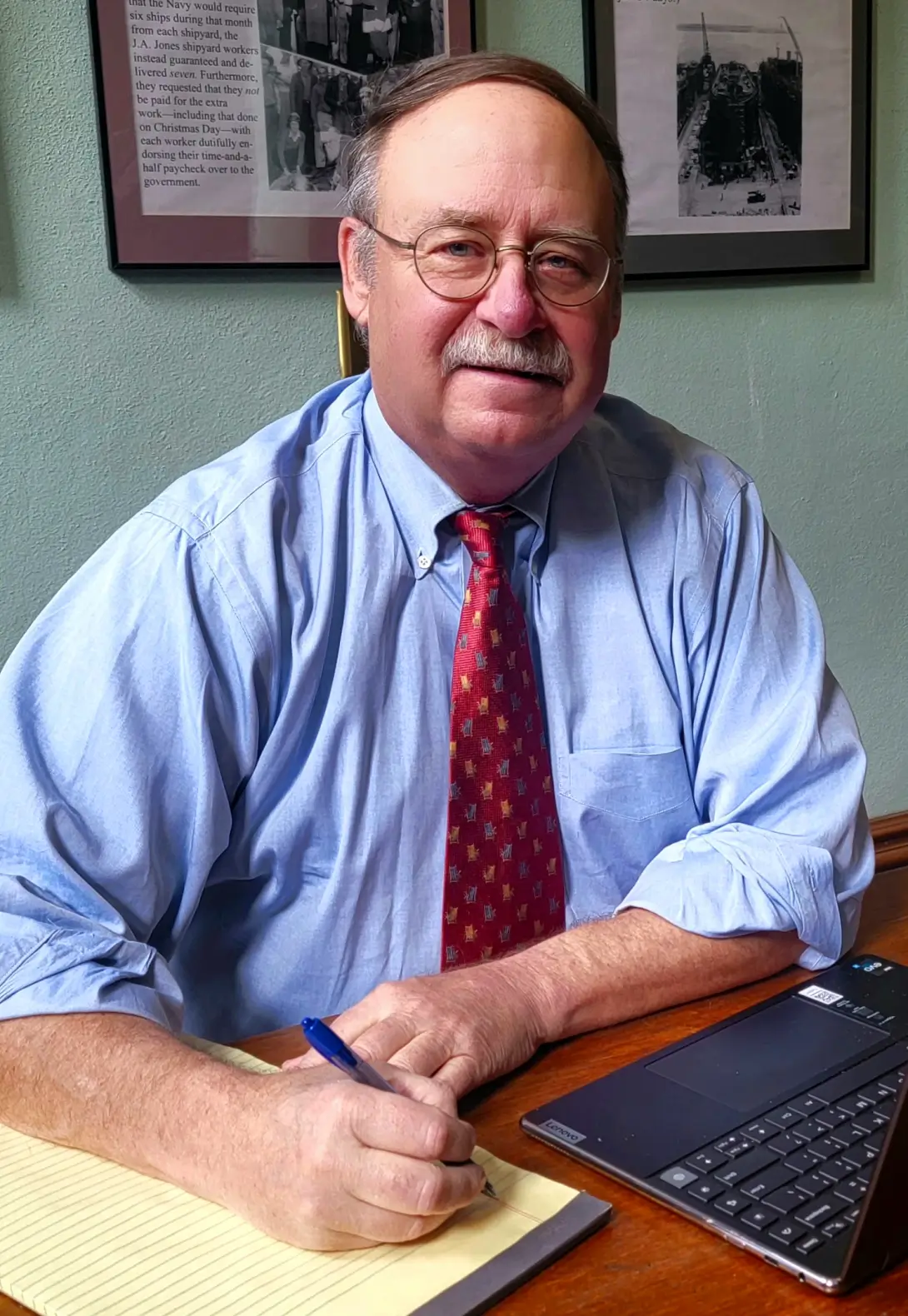 Attorney Robert Mues sitting at his desk.